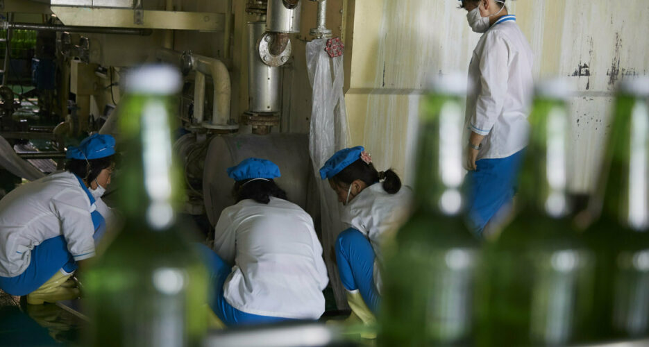 North Korea warns workers about COVID-19, boosts domestic face mask production