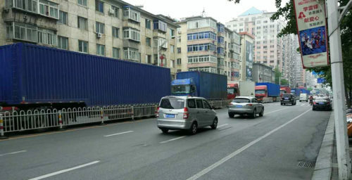 Convoy of trucks seen crossing from China to North Korea under police escort