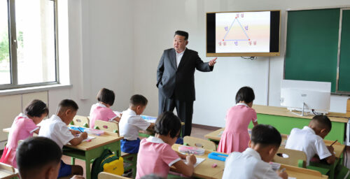 Kim Jong Un poses as father and teacher to children displaced by floods